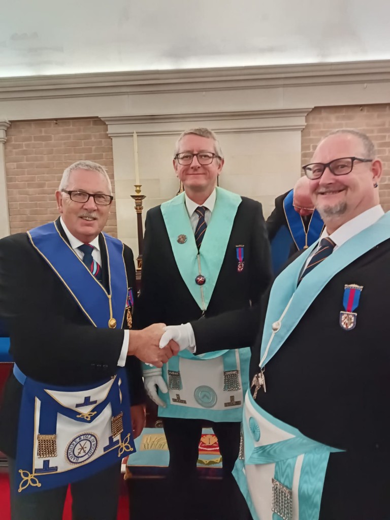 Three Freemasons welcoming with a handshake